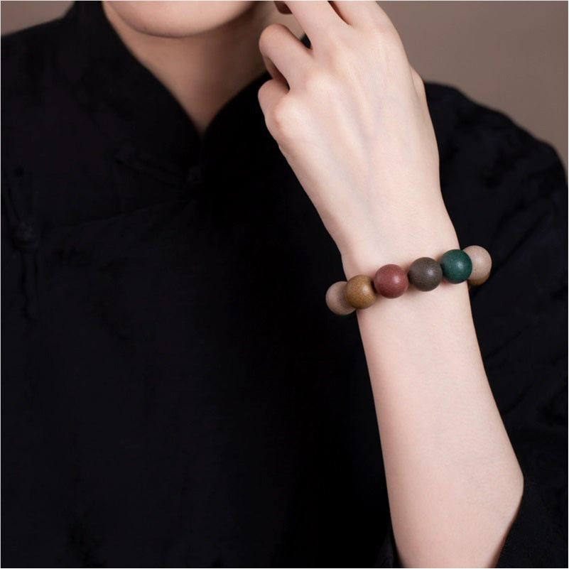 A person wearing a Chinese Five - Elements Herbal Incense Bead Bracelet on their wrist, highlighting the traditional Chinese medicine - inspired beads and the bracelet's stylish appearance.